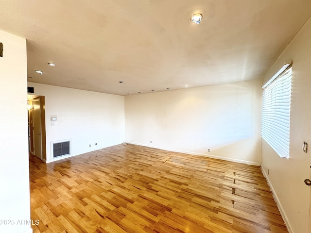 1702 W Tuckey Ln Unit 209, Phoenix, AZ 85015 - spare room with light wood-style flooring and baseboards