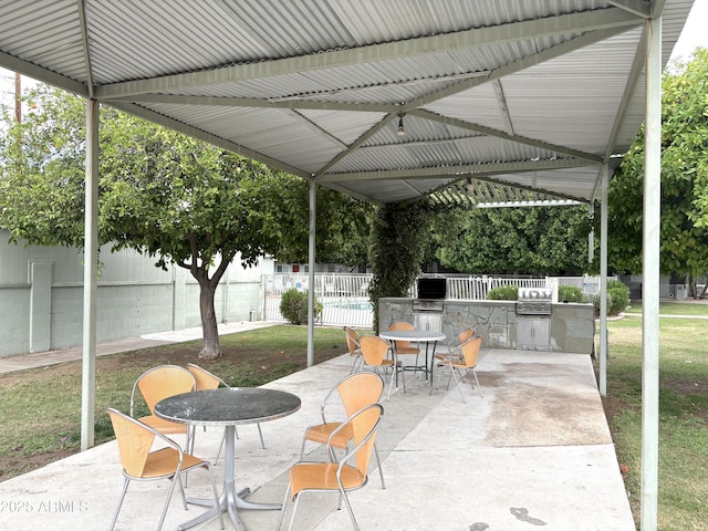 1702 W Tuckey Ln Unit 209, Phoenix, AZ 85015 - view of patio featuring an outdoor kitchen, fence, a grill, outdoor dining area, and a gazebo