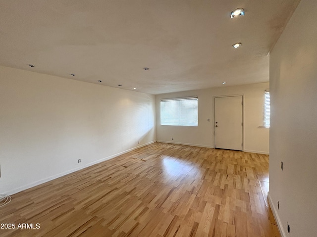 1702 W Tuckey Ln Unit 209, Phoenix, AZ 85015 - unfurnished room featuring light wood finished floors, baseboards, and recessed lighting