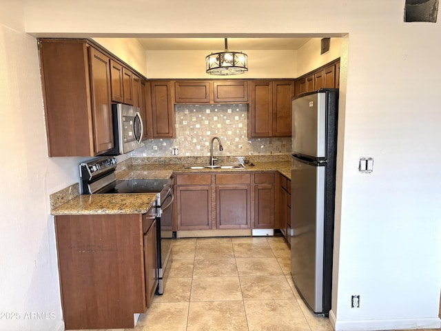 1702 W Tuckey Ln Unit 209, Phoenix, AZ 85015 - kitchen featuring stainless steel appliances, a sink, decorative backsplash, stone countertops, and pendant lighting