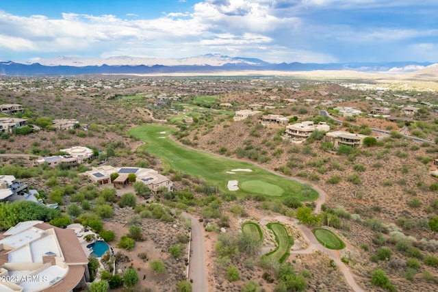 aerial view with view of golf course and a mountain view