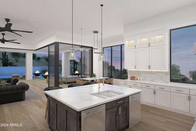 kitchen with dishwasher, open floor plan, and a sink