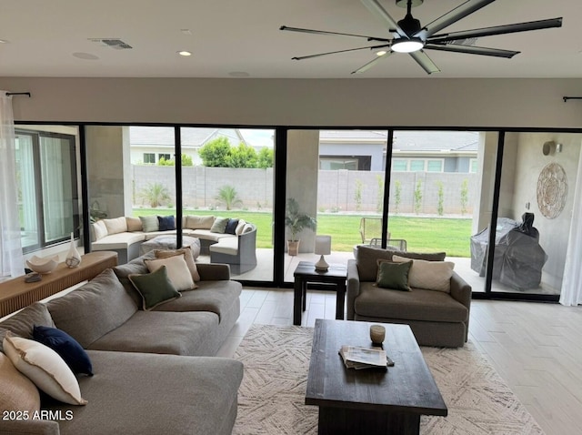 living area featuring a healthy amount of sunlight, ceiling fan, recessed lighting, and visible vents