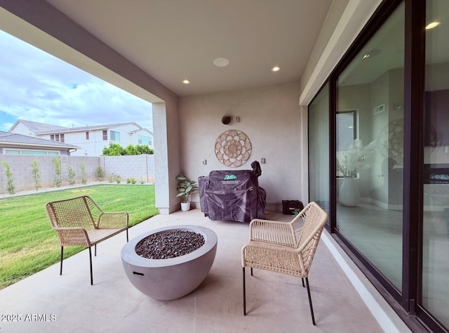 view of patio / terrace featuring an outdoor fire pit and fence