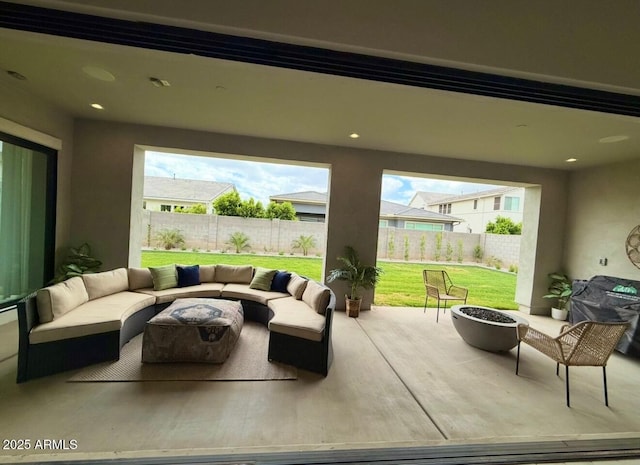 view of patio / terrace featuring a fenced backyard and an outdoor living space with a fire pit