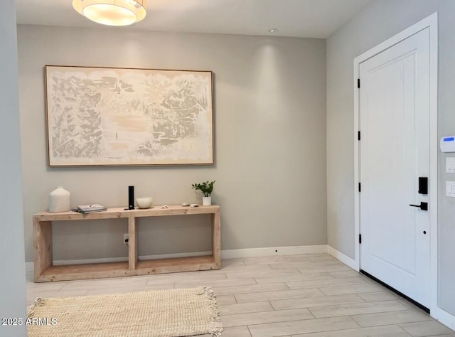 entrance foyer with wood tiled floor, baseboards, and recessed lighting