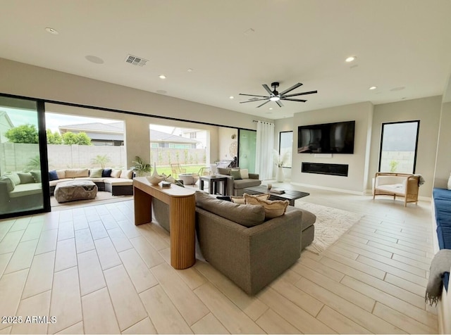 living room featuring recessed lighting, ceiling fan, light wood-type flooring, and visible vents