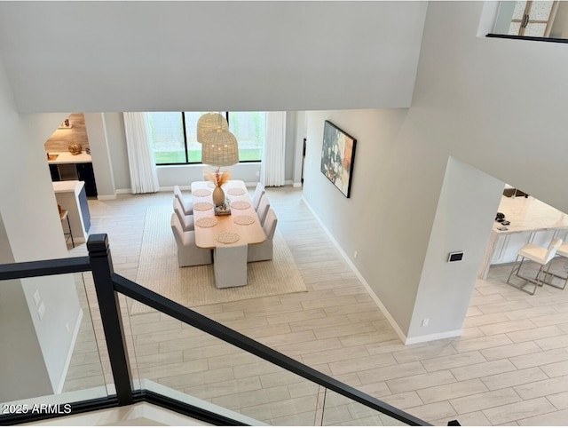 corridor featuring baseboards and wood finished floors