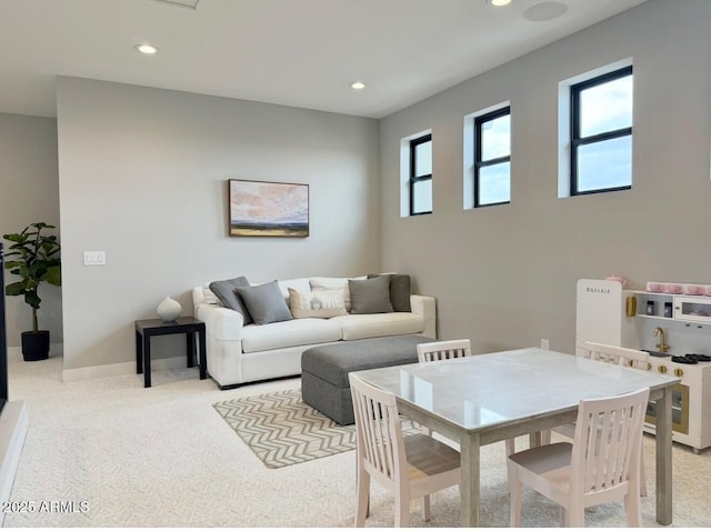 living room with carpet floors, baseboards, and recessed lighting