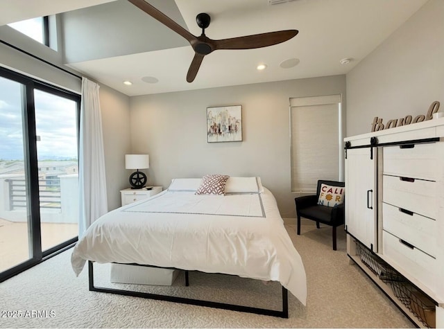 bedroom with a ceiling fan, a barn door, access to outside, light carpet, and recessed lighting
