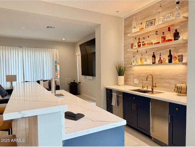 bar featuring a sink, dishwasher, recessed lighting, wet bar, and visible vents