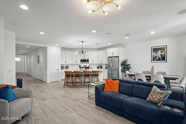 435 E Shellie Ct, Casa Grande, AZ 85122 - living room with a chandelier, light wood-type flooring, and recessed lighting