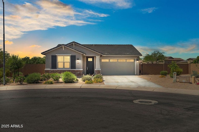 435 E Shellie Ct, Casa Grande, AZ 85122 - view of front of home featuring driveway, a garage, stone siding, stucco siding, and a tile roof