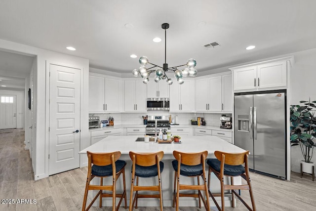 435 E Shellie Ct, Casa Grande, AZ 85122 - kitchen featuring stainless steel appliances, a sink, light countertops, white cabinetry, and recessed lighting