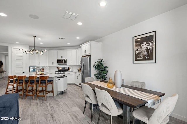 435 E Shellie Ct, Casa Grande, AZ 85122 - dining space featuring recessed lighting, light wood-style flooring, and a chandelier