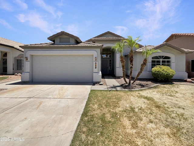 317 E Nunneley Rd, Gilbert, AZ 85296 - mediterranean / spanish-style house featuring concrete driveway, stucco siding, an attached garage, and a tile roof