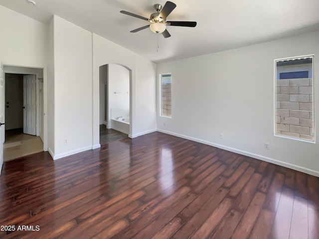 317 E Nunneley Rd, Gilbert, AZ 85296 - empty room with dark wood-type flooring, arched walkways, ceiling fan, and a smoke detector