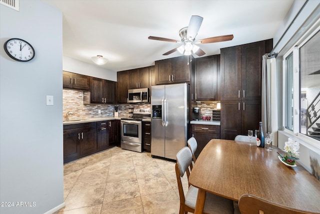 kitchen featuring backsplash, dark brown cabinetry, sink, and stainless steel appliances