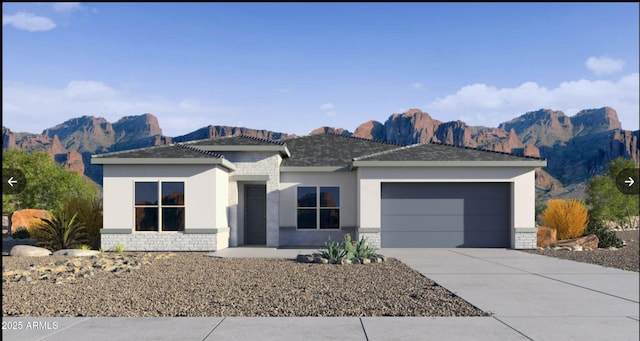 view of front facade featuring stucco siding, a mountain view, a garage, stone siding, and driveway