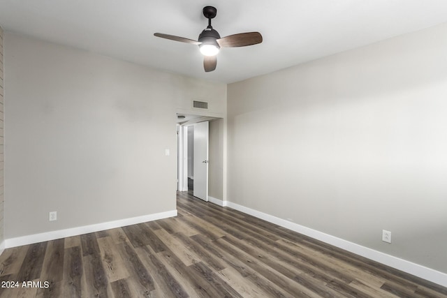 unfurnished room with ceiling fan and dark hardwood / wood-style flooring