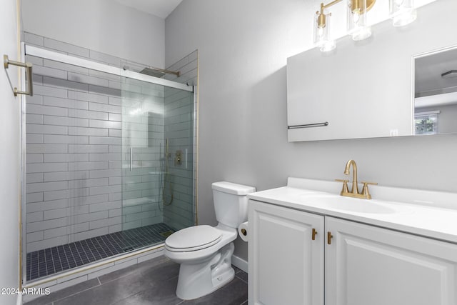 bathroom featuring vanity, toilet, and an enclosed shower