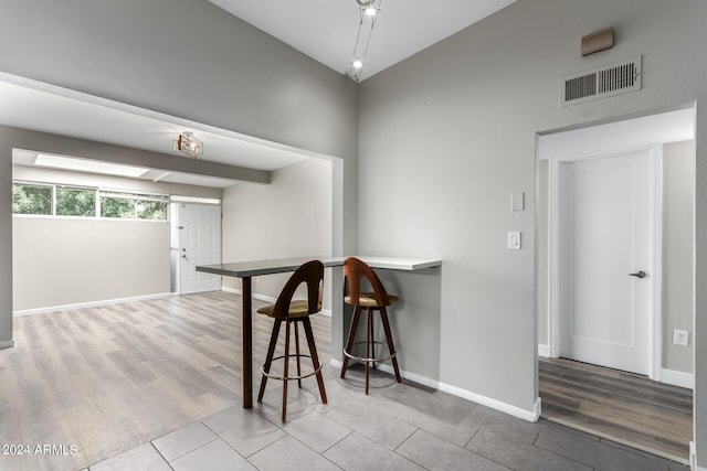 interior space featuring lofted ceiling and light tile patterned floors