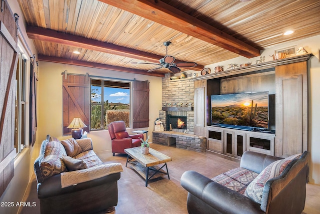 living room featuring a brick fireplace, wooden ceiling, beamed ceiling, ceiling fan, and a barn door