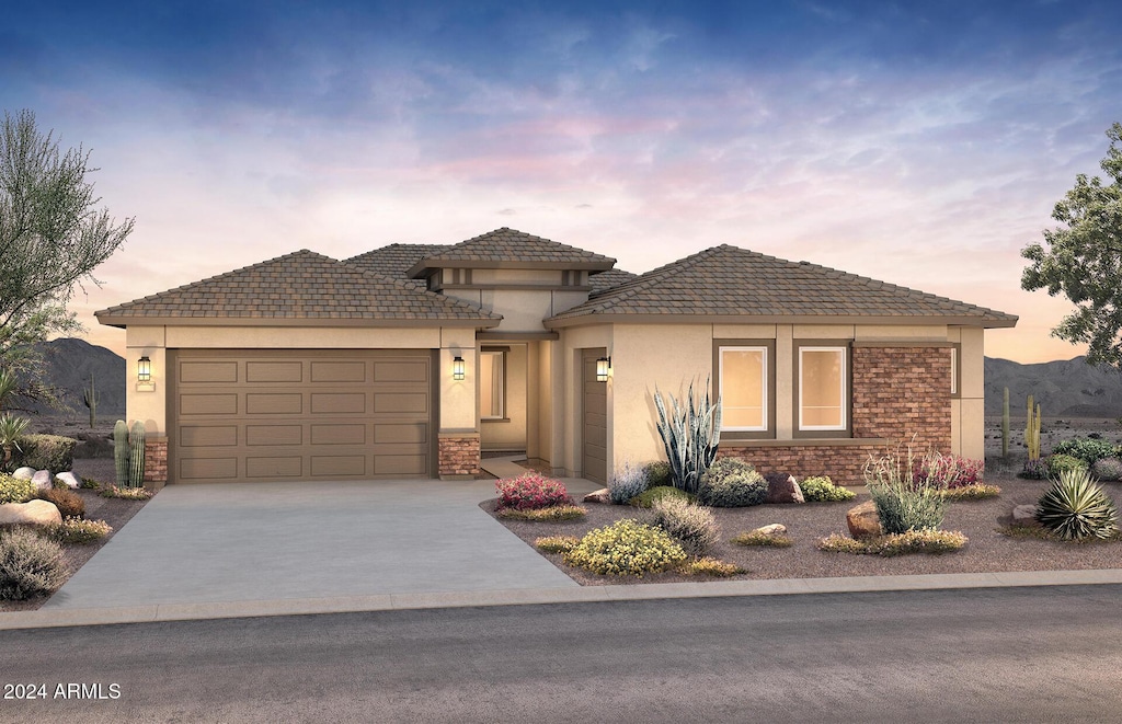 prairie-style home featuring a mountain view and a garage