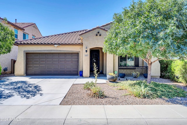 mediterranean / spanish-style home featuring a garage