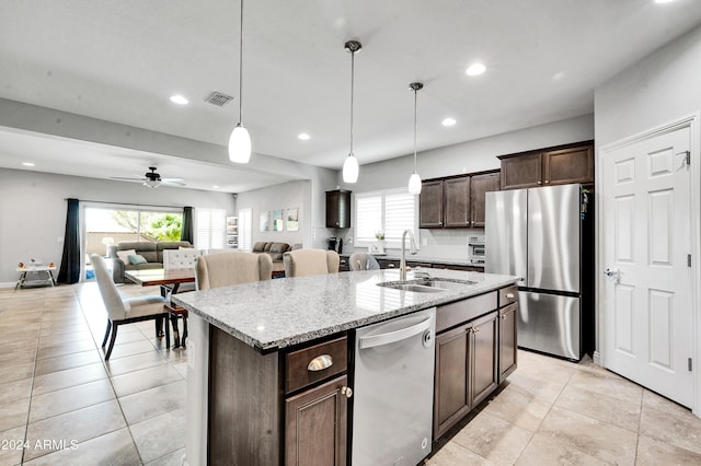 kitchen featuring an island with sink, ceiling fan, appliances with stainless steel finishes, and sink