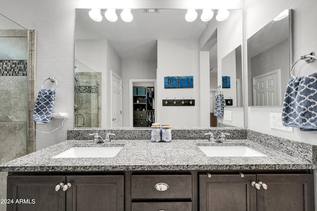 bathroom featuring vanity and a shower with shower door