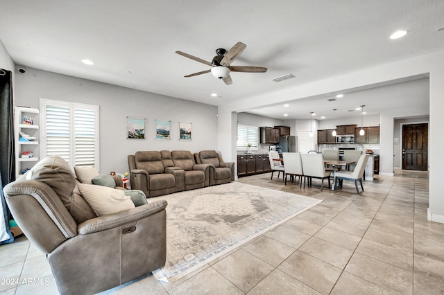 tiled living room featuring ceiling fan