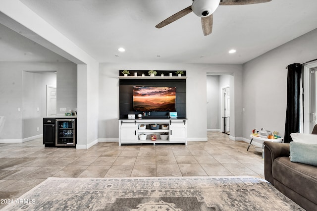 tiled living room featuring beverage cooler and ceiling fan