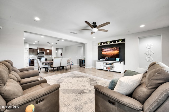 tiled living room with ceiling fan