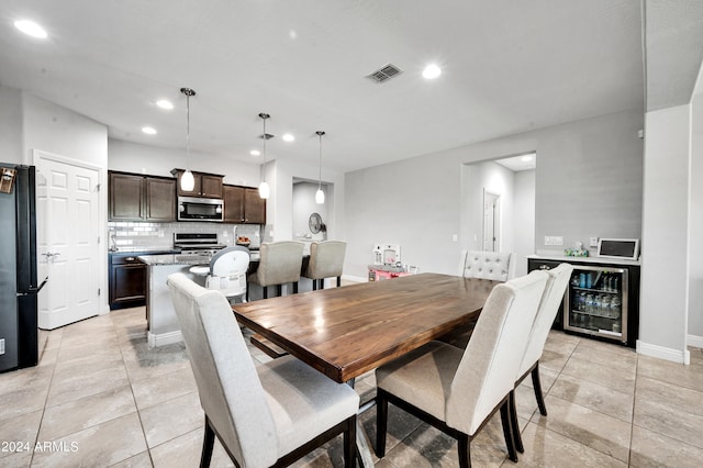 dining area with beverage cooler and light tile patterned floors