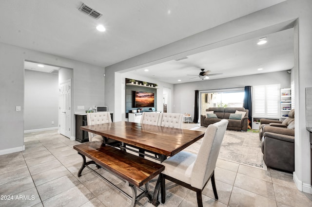 dining space with ceiling fan and light tile patterned floors