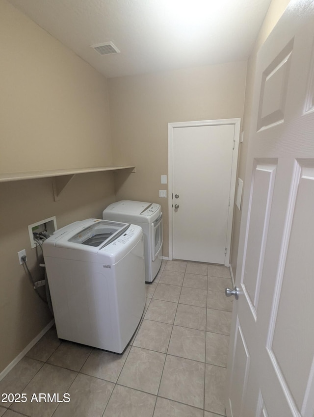 14841 W Desert Hills Dr, Surprise, AZ 85379 - washroom featuring washer and clothes dryer and light tile patterned flooring