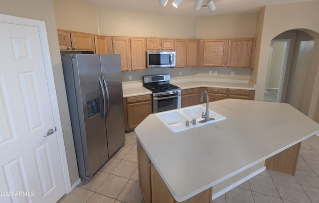 14841 W Desert Hills Dr, Surprise, AZ 85379 - kitchen featuring stainless steel appliances, a sink, light tile patterned floors, and a center island with sink