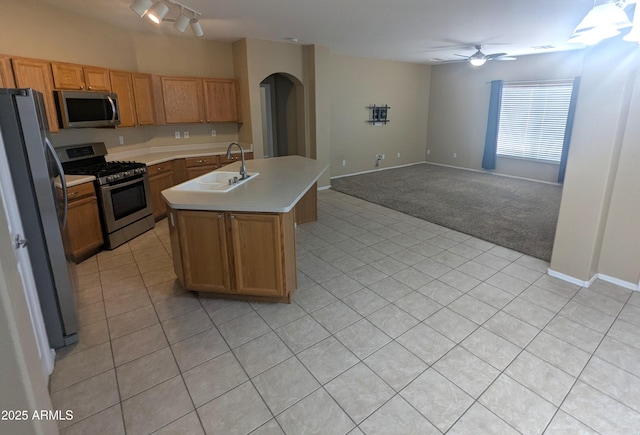14841 W Desert Hills Dr, Surprise, AZ 85379 - kitchen with appliances with stainless steel finishes, a sink, arched walkways, light countertops, and ceiling fan