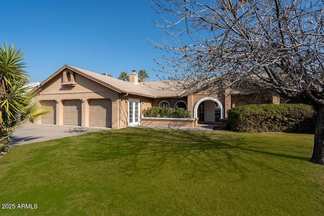 view of front of home featuring a garage and a front lawn