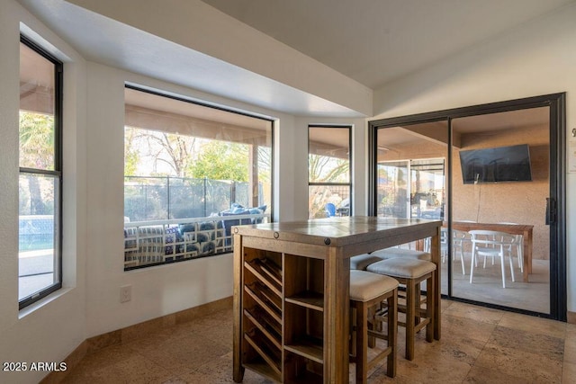 dining room with vaulted ceiling