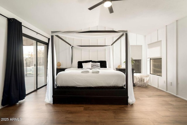 bedroom with lofted ceiling, access to exterior, hardwood / wood-style floors, and ceiling fan