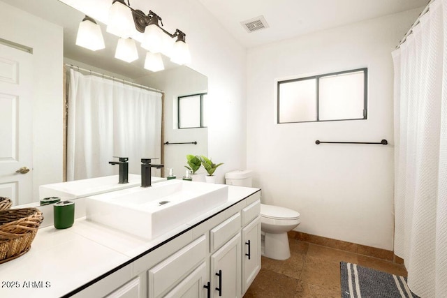 bathroom with vanity, toilet, and walk in shower