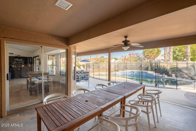 view of patio featuring a fenced in pool and ceiling fan