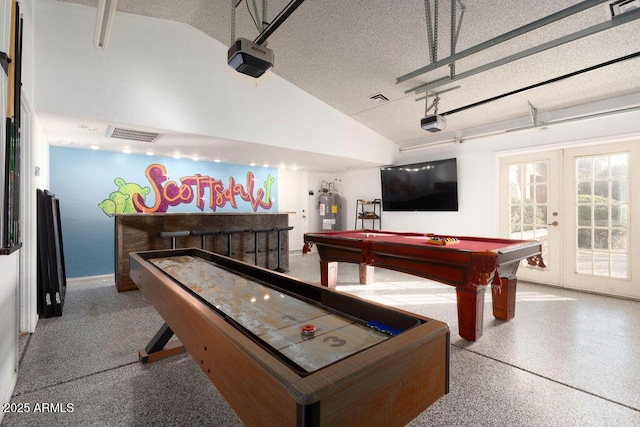 recreation room with french doors, billiards, vaulted ceiling, and a textured ceiling