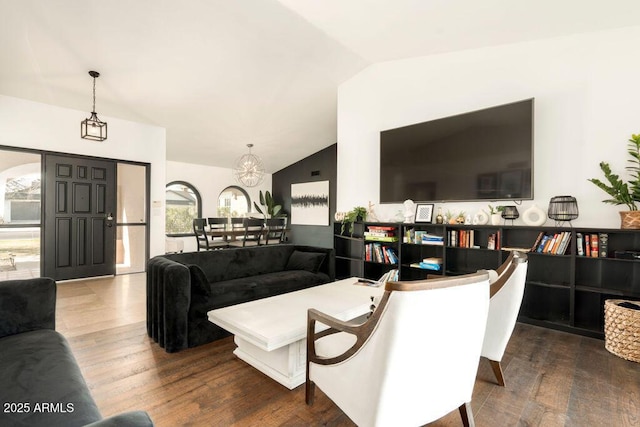 living room with lofted ceiling and hardwood / wood-style flooring