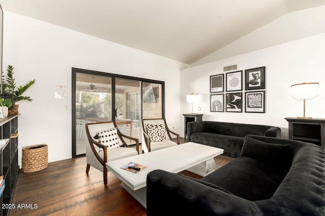 living room featuring lofted ceiling and dark hardwood / wood-style floors