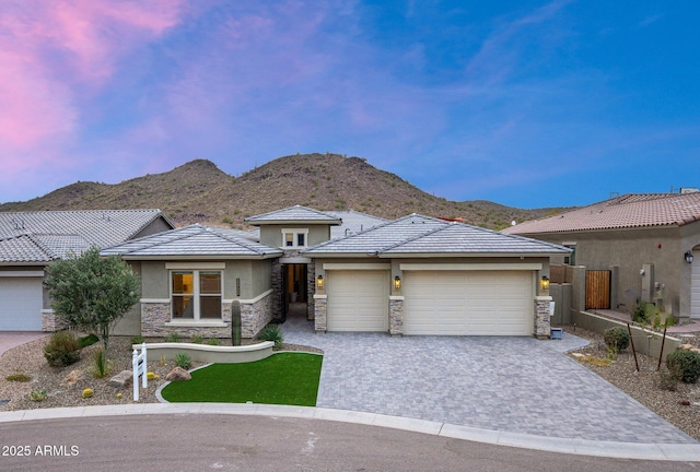 prairie-style house with a garage and a mountain view