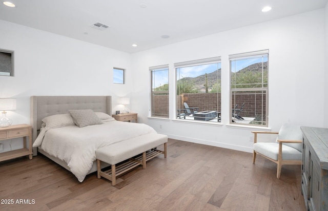 bedroom with hardwood / wood-style floors