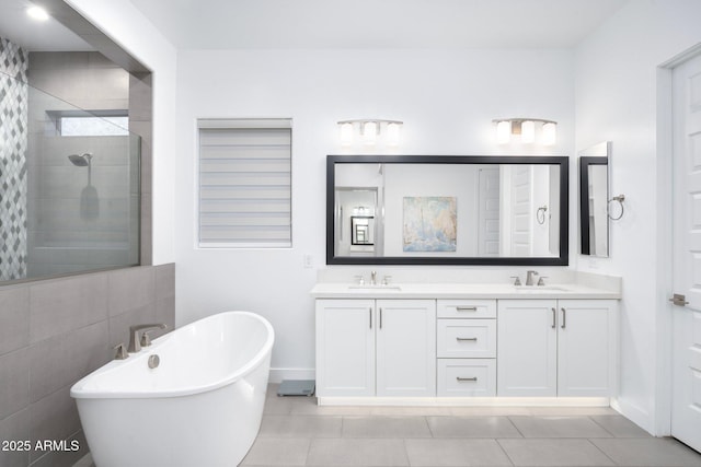 bathroom with tile patterned floors, separate shower and tub, and vanity